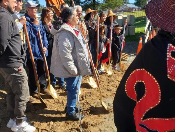 Photo of crew smiling for camera for ground breaking